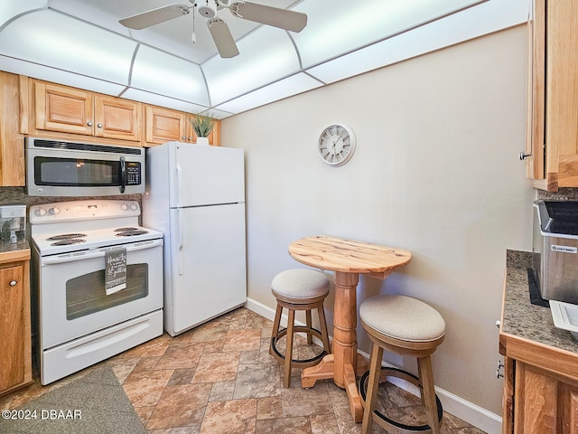 kitchen featuring a paneled ceiling, ceiling fan, and white appliances