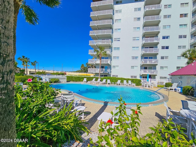 view of swimming pool featuring a patio area