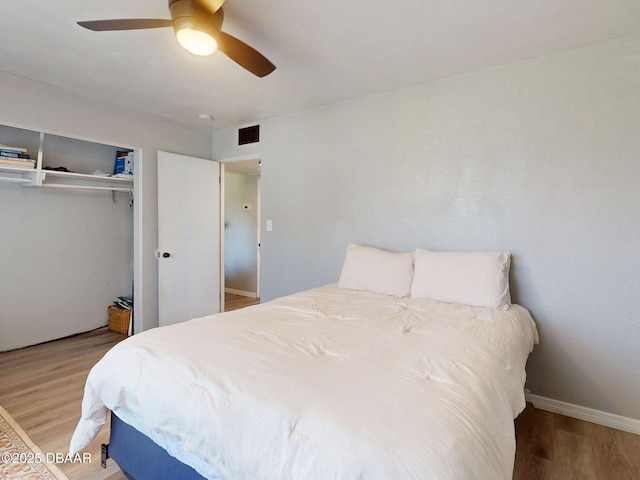 903 Conrad Dr, New Smyrna Beach, FL 32168 - bedroom with wood finished floors, a closet, and ceiling fan