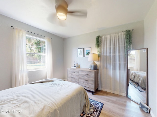 903 Conrad Dr, New Smyrna Beach, FL 32168 - bedroom with light wood-style floors and a ceiling fan