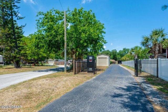1018 Green Acres Cir Unit N, South Daytona, FL 32119 - view of asphalt driveway with a gate and a gated entry