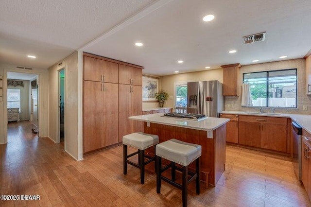 1018 Green Acres Cir Unit N, South Daytona, FL 32119 - kitchen featuring appliances with stainless steel finishes, light wood-style floors, healthy amount of natural light, a kitchen island, and recessed lighting