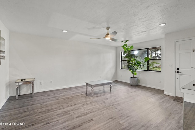 spare room featuring ceiling fan, hardwood / wood-style floors, and a textured ceiling