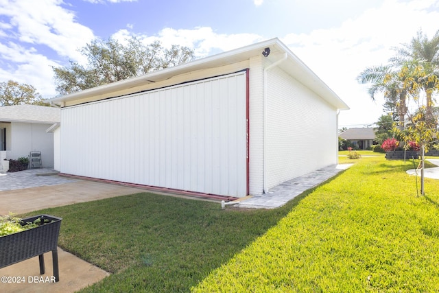 view of side of property with a lawn and a patio