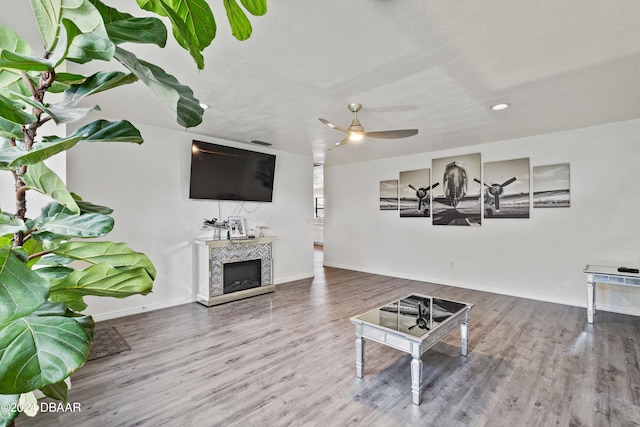 living room featuring hardwood / wood-style flooring and ceiling fan