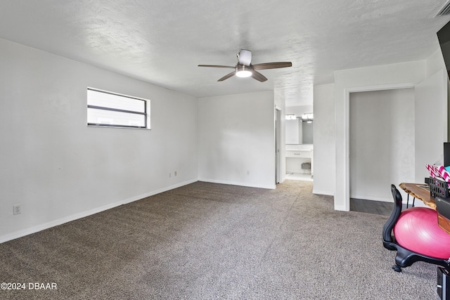 workout area with carpet, ceiling fan, and a textured ceiling