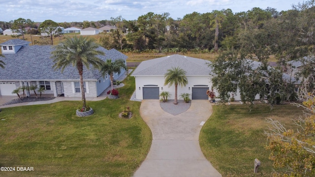 view of front of house with a garage and a front yard