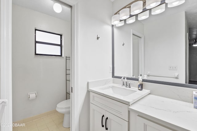 bathroom with tile patterned floors, vanity, and toilet