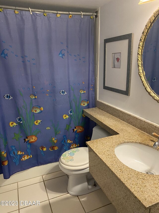 2301 S Atlantic Ave Unit 120, Daytona Beach Shores, FL 32118 - bathroom with tile patterned flooring, toilet, vanity, and curtained shower
