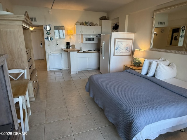 2301 S Atlantic Ave Unit 120, Daytona Beach Shores, FL 32118 - bedroom featuring light tile patterned flooring