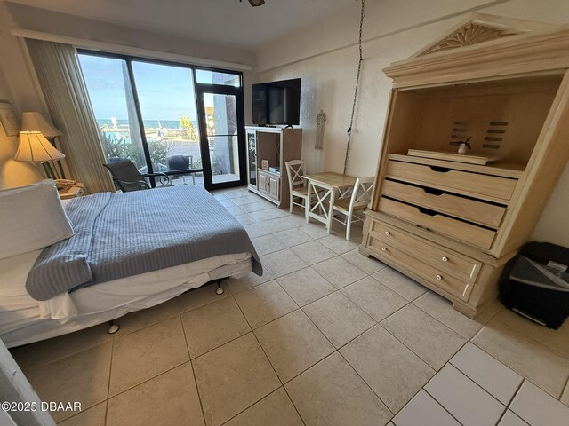 2301 S Atlantic Ave Unit 120, Daytona Beach Shores, FL 32118 - bedroom with light tile patterned flooring and access to exterior