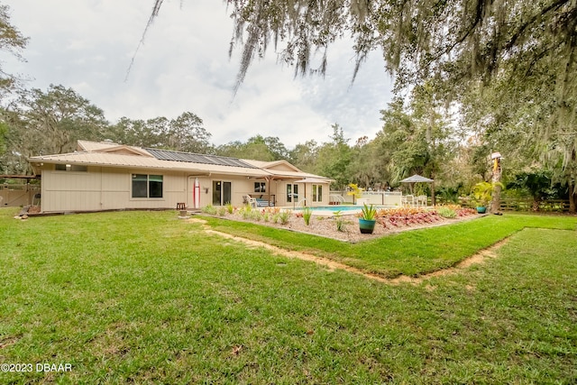 back of property with a patio and a lawn