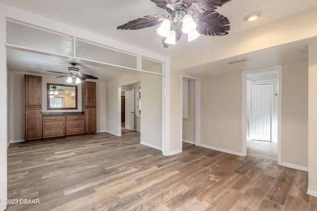 unfurnished living room with hardwood / wood-style flooring and ceiling fan