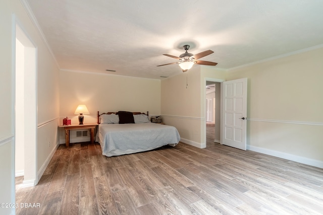 bedroom with hardwood / wood-style floors, ceiling fan, and ornamental molding