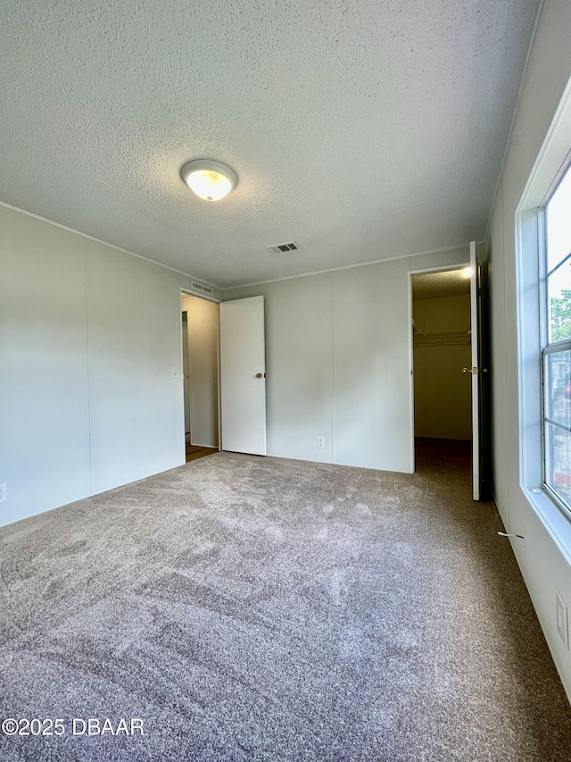1910 Woodcrest Dr, Ormond Beach, FL 32174 - unfurnished bedroom featuring a textured ceiling and carpet