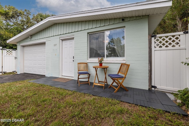 127 Bosarvey Dr, Ormond Beach, FL 32176 - garage featuring a gate and driveway