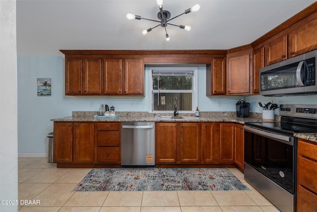 127 Bosarvey Dr, Ormond Beach, FL 32176 - kitchen with stainless steel appliances, a chandelier, light stone counters, and light tile patterned floors