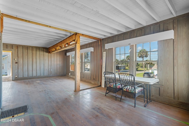 sunroom featuring beamed ceiling and wooden ceiling