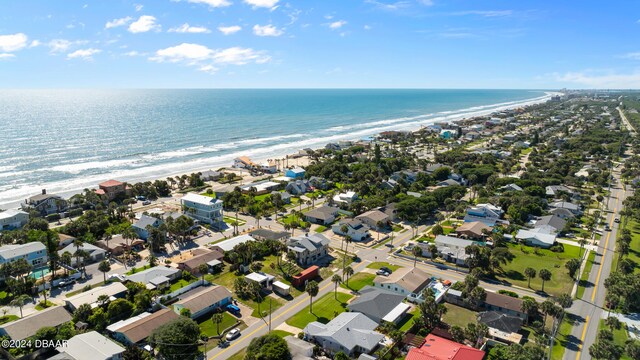 drone / aerial view with a beach view and a water view