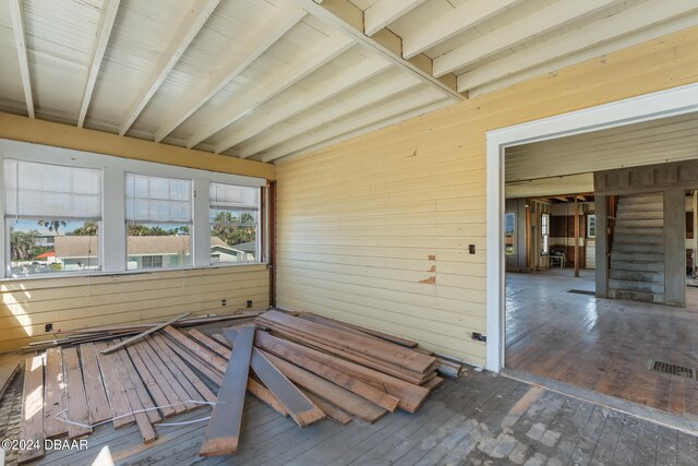 unfurnished sunroom with beam ceiling