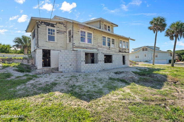 rear view of property with a garage