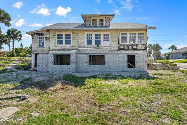 back of house with a lawn