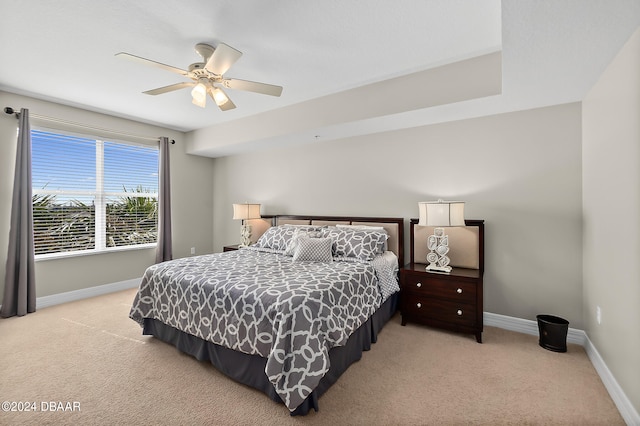 bedroom with light carpet and ceiling fan