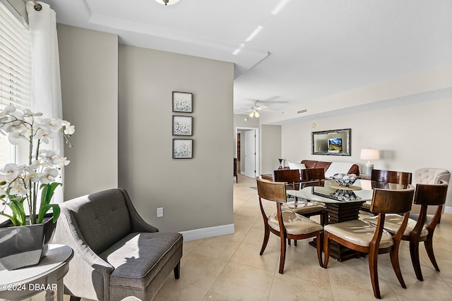 tiled dining space featuring ceiling fan