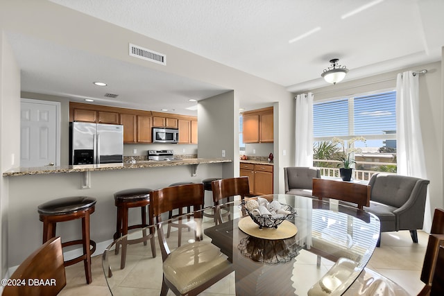 dining area with light tile patterned floors