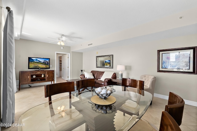 tiled living room with ceiling fan