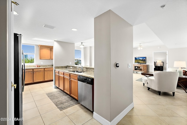 kitchen featuring light tile patterned floors, plenty of natural light, sink, and appliances with stainless steel finishes