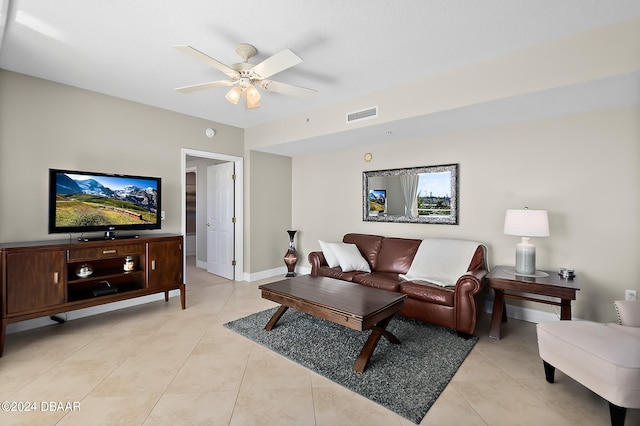 tiled living room with ceiling fan