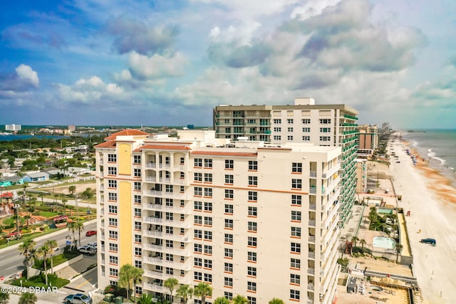 view of building exterior featuring a view of the beach and a water view