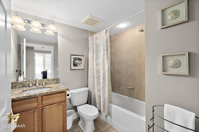 full bathroom featuring tile patterned flooring, vanity, a textured ceiling, and shower / bathtub combination with curtain