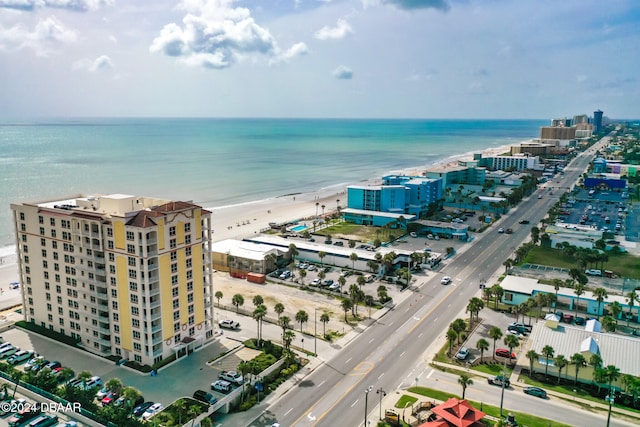 bird's eye view featuring a water view and a beach view