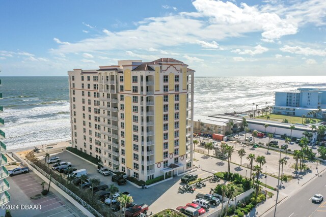 drone / aerial view with a water view and a view of the beach