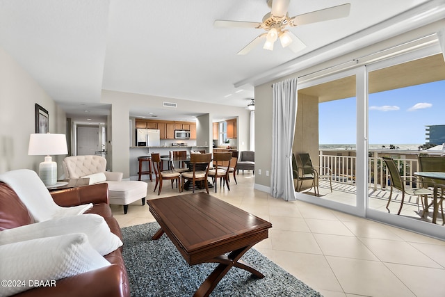 tiled living room with ceiling fan