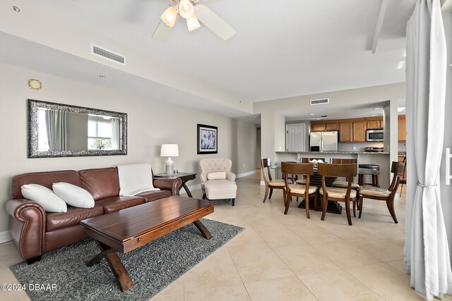 living room with ceiling fan and light tile patterned floors