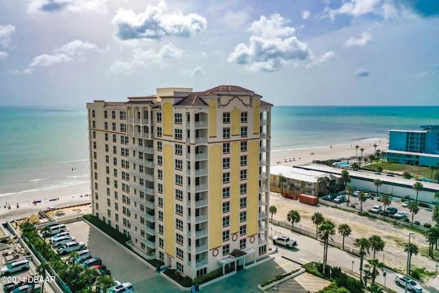 view of property with a beach view and a water view