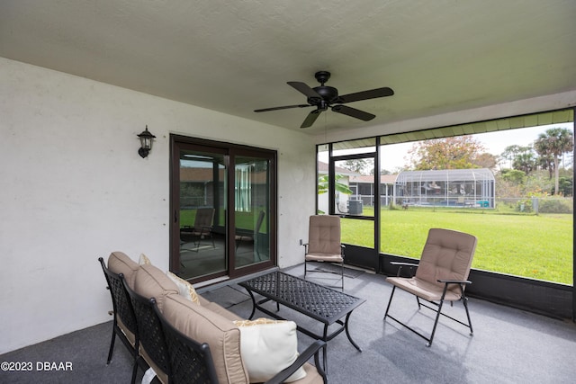 sunroom / solarium featuring ceiling fan