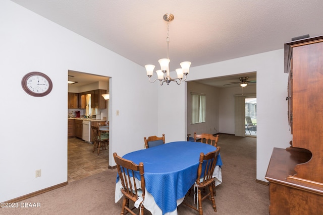 carpeted dining area featuring ceiling fan with notable chandelier