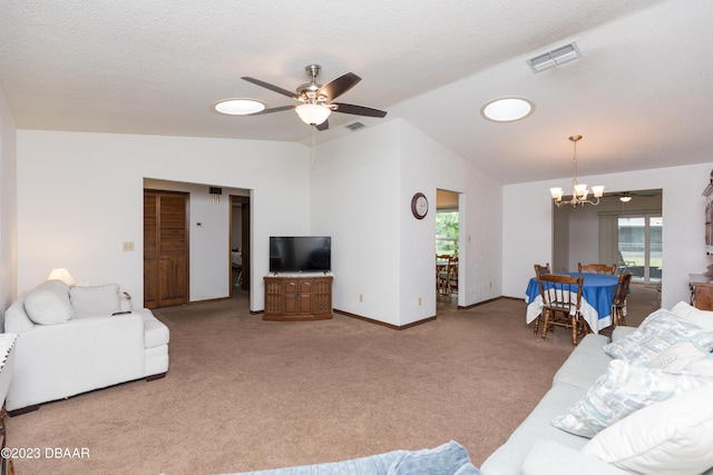 carpeted living room featuring a textured ceiling, ceiling fan with notable chandelier, and lofted ceiling