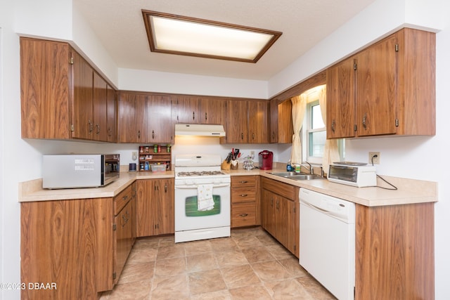 kitchen featuring a textured ceiling, white appliances, and sink