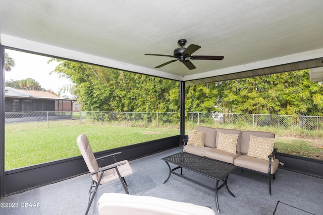 sunroom / solarium featuring ceiling fan