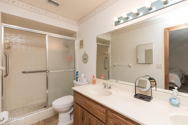 bathroom with vanity, toilet, and a shower with shower door