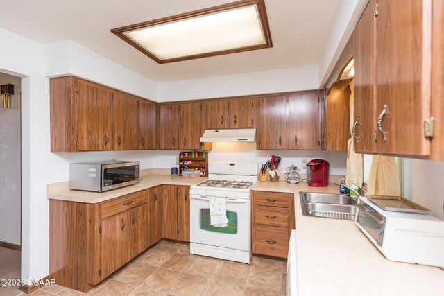 kitchen featuring white range with gas cooktop and sink