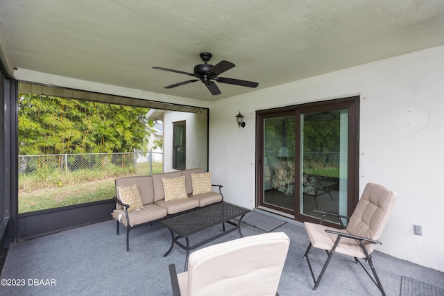 sunroom featuring ceiling fan