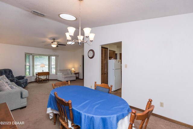 dining area featuring carpet flooring, a textured ceiling, and ceiling fan with notable chandelier