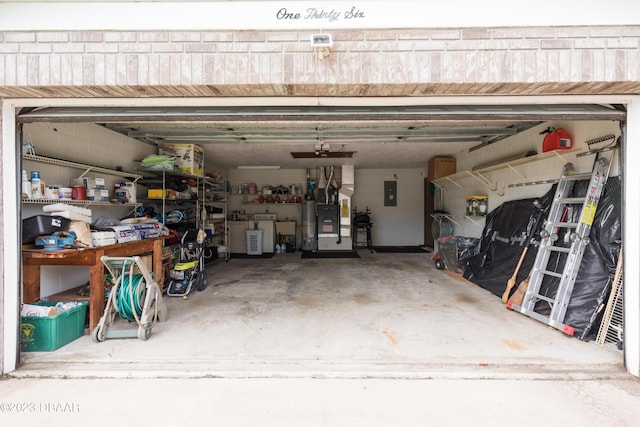 garage featuring independent washer and dryer, electric panel, and heating unit