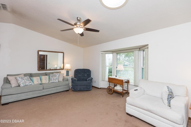 living room with a textured ceiling, ceiling fan, light carpet, and lofted ceiling